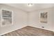 Bright bedroom with wood-look floors, neutral walls, and two windows providing natural light at 165 Holly Nw Rd, Atlanta, GA 30314