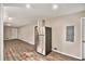 Spacious open-concept living space featuring wood floors and a stainless steel refrigerator at 165 Holly Nw Rd, Atlanta, GA 30314