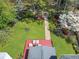 A bird's eye view shows a well-manicured backyard with patio and firepit with greenery surrounding the space at 1665 Millhouse Lndg, Marietta, GA 30066