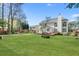 A large backyard featuring green grass, gardens, and a deck adjacent to the house at 1665 Millhouse Lndg, Marietta, GA 30066