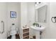 Chic half bath features a pedestal sink, modern fixtures, and stylish decor at 1665 Millhouse Lndg, Marietta, GA 30066