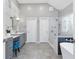 Modern bathroom featuring dual vanities, a soaking tub, a glass shower, and hexagon tile floor at 1665 Millhouse Lndg, Marietta, GA 30066