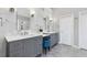 Modern bathroom featuring dual vanities, marble accents, hexagon tile floor, and stylish lighting at 1665 Millhouse Lndg, Marietta, GA 30066
