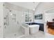 Modern bathroom featuring a glass shower, soaking tub, and stylish tile work, perfect for relaxation at 1665 Millhouse Lndg, Marietta, GA 30066