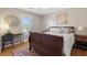 Cozy bedroom features hardwood floors, a desk, a bedside table, and a red patterned rug at 1665 Millhouse Lndg, Marietta, GA 30066