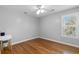 Bright bedroom with hardwood floors, white trim, ceiling fan, and a large window with blinds at 1665 Millhouse Lndg, Marietta, GA 30066