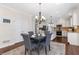 Charming dining room with stylish chandelier, and convenient access to the kitchen at 1665 Millhouse Lndg, Marietta, GA 30066