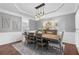 Elegant dining room featuring modern lighting, gray walls, and wainscoting details at 1665 Millhouse Lndg, Marietta, GA 30066