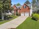 Charming two-story brick home with a well-manicured lawn and a two-car garage at 1665 Millhouse Lndg, Marietta, GA 30066