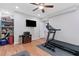 Well-equipped home gym with a treadmill, ample storage, and a wall-mounted TV for convenient workout sessions at 1665 Millhouse Lndg, Marietta, GA 30066