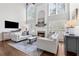Bright living room with fireplace, large windows, and comfortable seating arrangement at 1665 Millhouse Lndg, Marietta, GA 30066