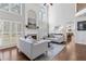 Bright living room boasts soaring ceilings, fireplace, hardwood floors, and natural light at 1665 Millhouse Lndg, Marietta, GA 30066