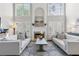 Bright living room with fireplace, large windows, and comfortable seating arrangement at 1665 Millhouse Lndg, Marietta, GA 30066