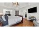 Spacious main bedroom with hardwood floors, a tray ceiling, and a mounted television at 1665 Millhouse Lndg, Marietta, GA 30066