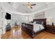 Spacious main bedroom featuring hardwood floors, tray ceiling, and a large window at 1665 Millhouse Lndg, Marietta, GA 30066
