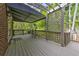 View of the spacious, shaded deck with lush greenery and outdoor seating at 1956 Grace Arbor Ne Ct, Atlanta, GA 30329