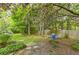 Landscaped backyard with a stone pathway and flowering trees, creating a serene outdoor space at 1956 Grace Arbor Ne Ct, Atlanta, GA 30329