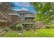 Back exterior view of a brick home with a multi-level deck and a well-manicured lawn at 1956 Grace Arbor Ne Ct, Atlanta, GA 30329