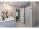 Bright bathroom featuring dual sinks and shower-tub combination with pretty shower curtain at 1956 Grace Arbor Ne Ct, Atlanta, GA 30329