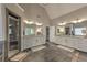 Spacious bathroom featuring double vanities, a glass-enclosed shower, tile flooring, and large mirrors at 1956 Grace Arbor Ne Ct, Atlanta, GA 30329