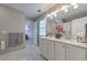 Bright bathroom with double vanity, white cabinets, a large mirror and lovely decor at 1956 Grace Arbor Ne Ct, Atlanta, GA 30329