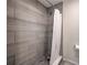 Modern bathroom shower with light gray tile and stylish fixtures with a shower curtain at 1956 Grace Arbor Ne Ct, Atlanta, GA 30329
