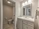 Clean and bright bathroom with modern sink and vanity, updated fixtures, and a toilet with a towel beside at 1956 Grace Arbor Ne Ct, Atlanta, GA 30329