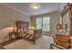 This is a cozy bedroom with an antique-style bed, a large window, and warm, inviting decor at 1956 Grace Arbor Ne Ct, Atlanta, GA 30329