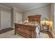 This is a traditional bedroom showcasing an ornate wooden bed and a tranquil atmosphere with neutral-toned walls at 1956 Grace Arbor Ne Ct, Atlanta, GA 30329