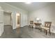 Empty flex room with hardwood floors, showing access to the adjacent rooms and ample natural light at 1956 Grace Arbor Ne Ct, Atlanta, GA 30329