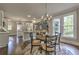 Open kitchen and dining area with stylish chandelier and views of the backyard at 1956 Grace Arbor Ne Ct, Atlanta, GA 30329