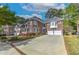 Charming brick home featuring a long driveway and a well-manicured lawn with colorful flowerbeds at 1956 Grace Arbor Ne Ct, Atlanta, GA 30329