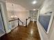 Spacious hallway with hardwood floors and decorative chandelier lighting at 1956 Grace Arbor Ne Ct, Atlanta, GA 30329