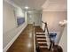 Upstairs hallway featuring hardwood floors and decorative wall art at 1956 Grace Arbor Ne Ct, Atlanta, GA 30329