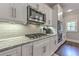 Close-up of the modern kitchen with stainless steel appliances and white cabinets at 1956 Grace Arbor Ne Ct, Atlanta, GA 30329