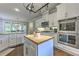 Bright kitchen boasts stainless appliances, white cabinets, a center island, and a dining area at 1956 Grace Arbor Ne Ct, Atlanta, GA 30329