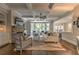 Open concept living room with fireplace, large windows, and seamless flow to the kitchen at 1956 Grace Arbor Ne Ct, Atlanta, GA 30329