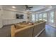 Comfortable living room showcasing a large sectional sofa and custom built ins under a large window bay at 1956 Grace Arbor Ne Ct, Atlanta, GA 30329