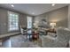 This home features a cozy living room with two large windows, natural light, and stylish furnishings at 1956 Grace Arbor Ne Ct, Atlanta, GA 30329