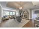 This open living room features a stone fireplace, lots of natural light, and hardwood floors at 1956 Grace Arbor Ne Ct, Atlanta, GA 30329