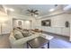Cozy living room with a large sectional sofa, ceiling fan, and custom-built shelving with flat screen tv at 1956 Grace Arbor Ne Ct, Atlanta, GA 30329