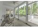 Inviting screened porch with ceiling fan and outdoor seating overlooking the wooded backyard at 1956 Grace Arbor Ne Ct, Atlanta, GA 30329