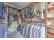 Walk-in closet with custom shelving and plenty of space for hanging and folded clothes at 1956 Grace Arbor Ne Ct, Atlanta, GA 30329