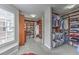 Spacious walk-in closet with custom shelving for shoes, clothes, and storage; featuring a window and carpeted floor at 1956 Grace Arbor Ne Ct, Atlanta, GA 30329