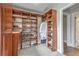 Walk-in closet features custom shelves and storage for shoes and clothes, with carpeted floor and open doorway at 1956 Grace Arbor Ne Ct, Atlanta, GA 30329