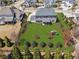 Aerial view of backyard showing a fenced yard, lawn, and mature landscaping, providing a private retreat at 214 Leland Way, Woodstock, GA 30188