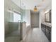 Modern bathroom with glass-enclosed shower and double vanity with ample storage space at 214 Leland Way, Woodstock, GA 30188