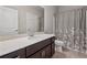 Bathroom featuring a vanity with a light countertop, and a shower with patterned curtain at 214 Leland Way, Woodstock, GA 30188