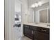 View of bathroom vanity through an open doorway to a bedroom with large bed and rug at 214 Leland Way, Woodstock, GA 30188