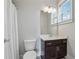 Cozy bathroom featuring a toilet, vanity, and window providing natural light at 214 Leland Way, Woodstock, GA 30188